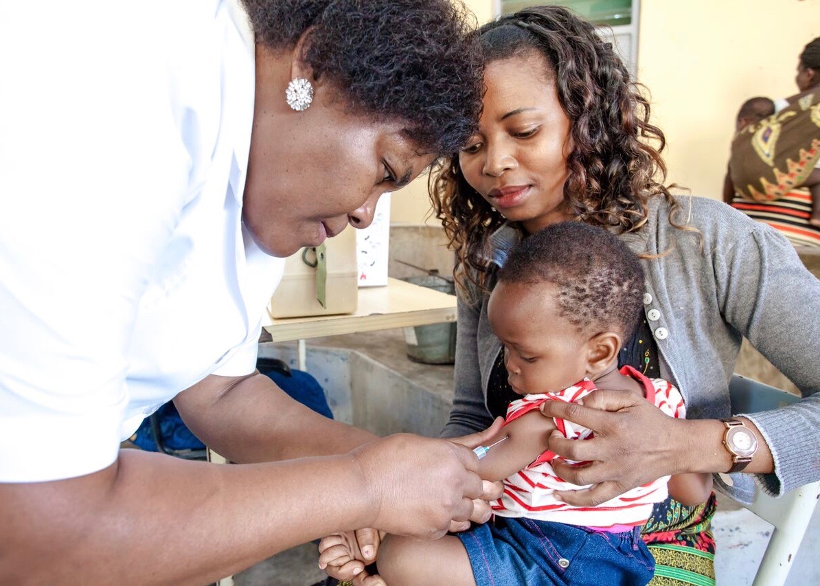 Nurse vaccinating child